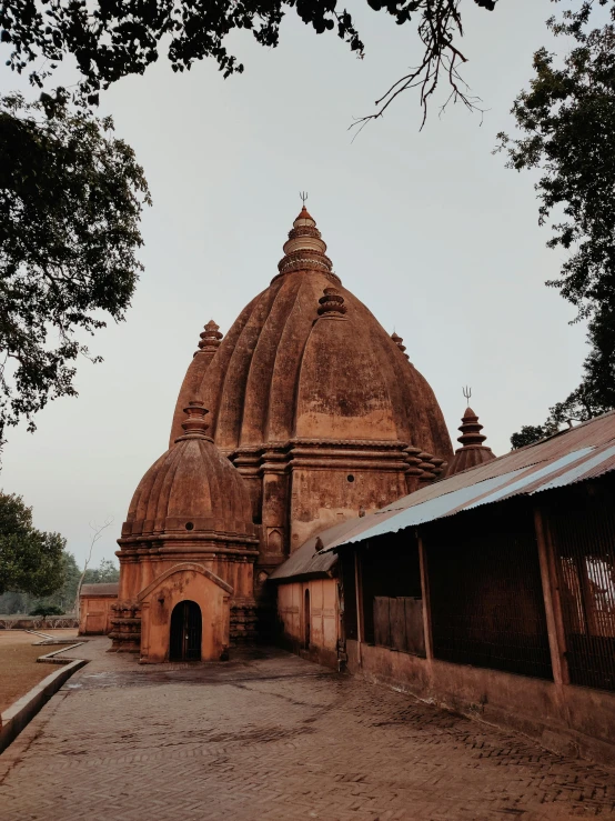 a large building sitting next to a dirt path