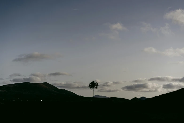 the sun is shining through the clouds near mountains