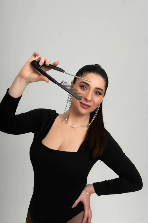 a woman holding a hair brush in her hand