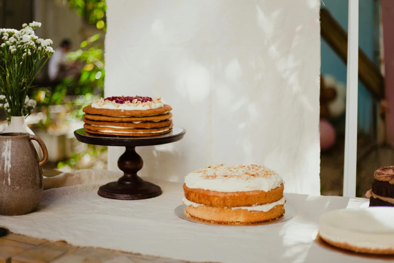 a cake, cupcakes and mug of coffee are on a table