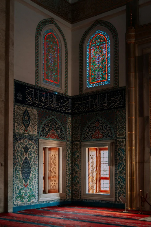 an ornate room with stained glass windows on the wall