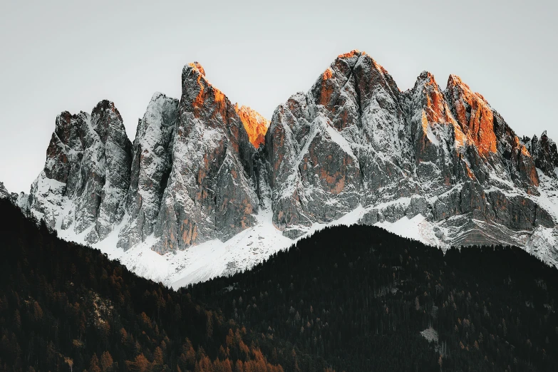 an orange snow on some snow covered mountains