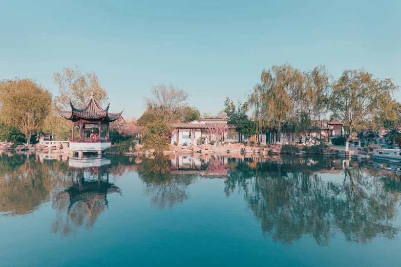 boats are in the water by a chinese style town