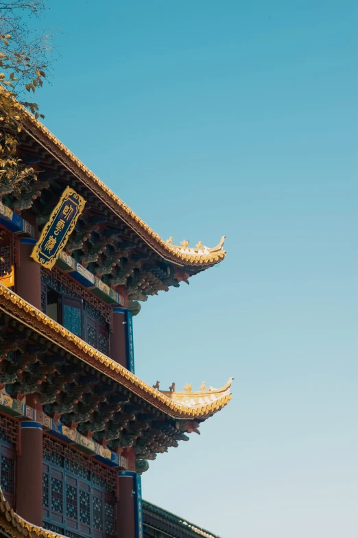 the top half of a tall building under a blue sky