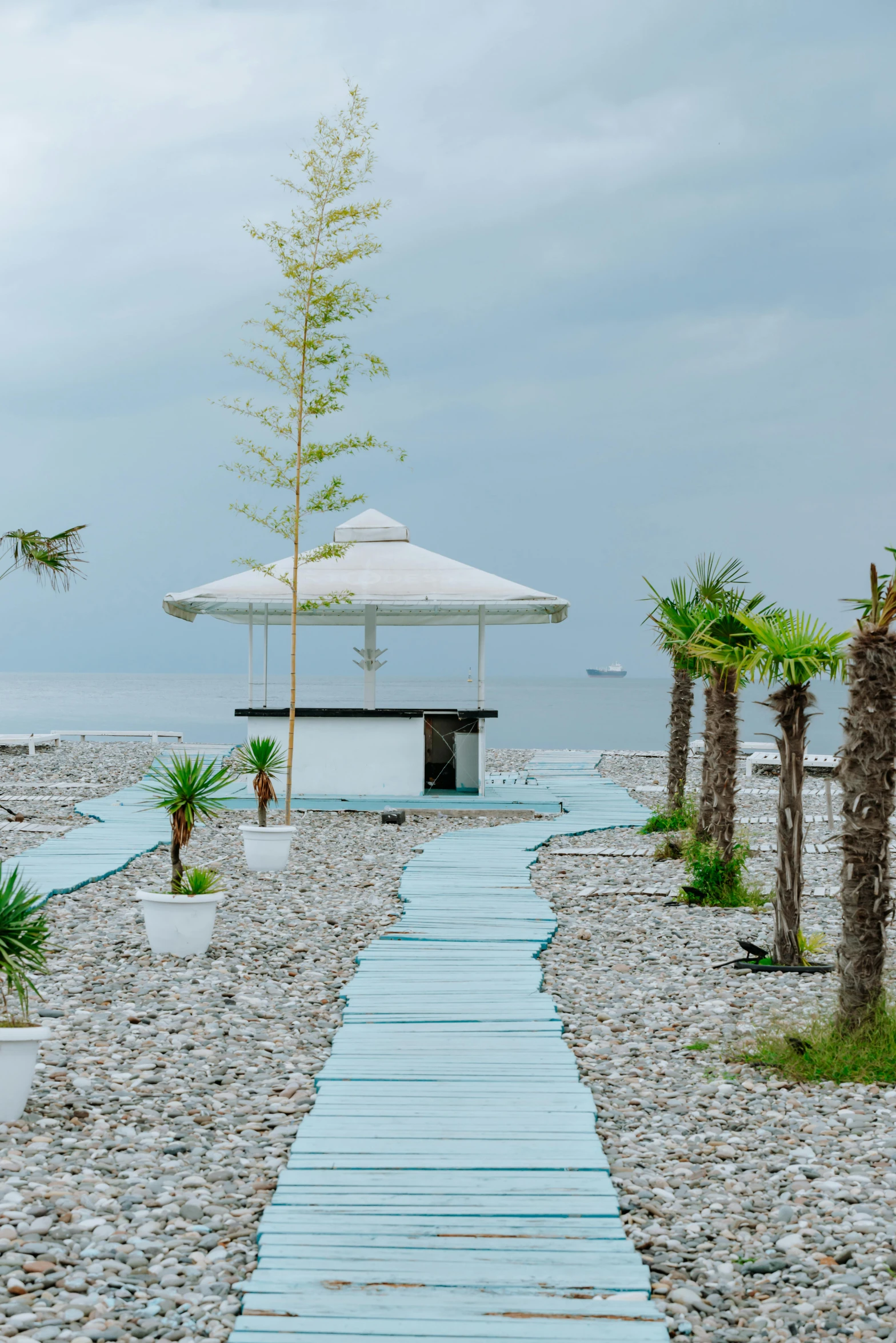 the view from the ocean's beach with white umbrellas