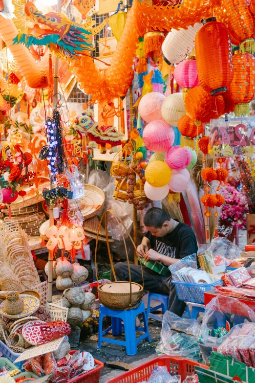 there is a man selling items in the market