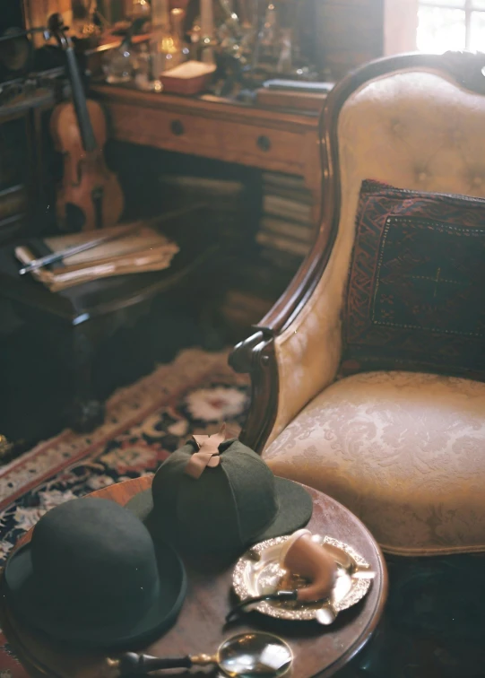 antique hat and fork sit on a table with a chair