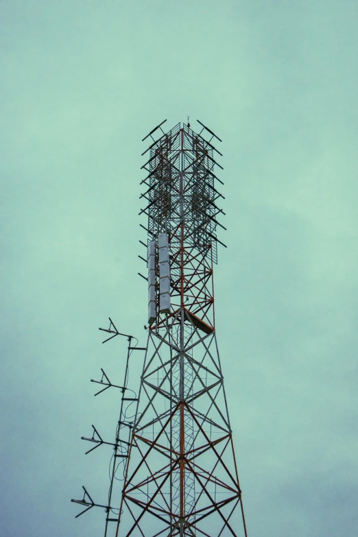 a tall, thin tower has several antennas on it