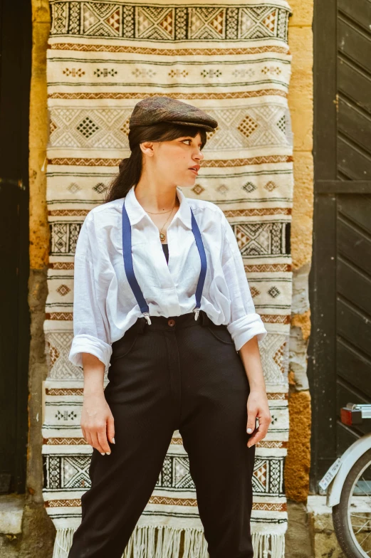 a woman wearing black pants and a white shirt