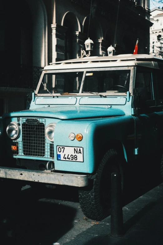 the old truck is parked on the side of the road