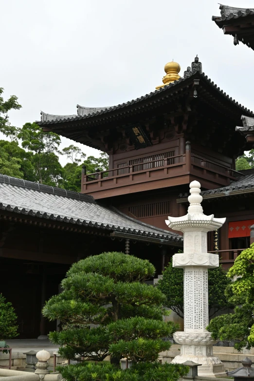 two ornate statues stand in front of a building