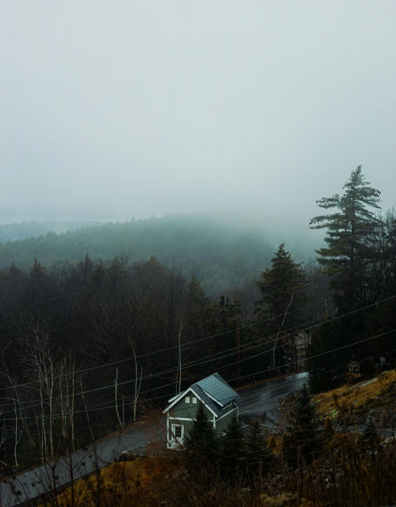 a house in the mountains surrounded by fog