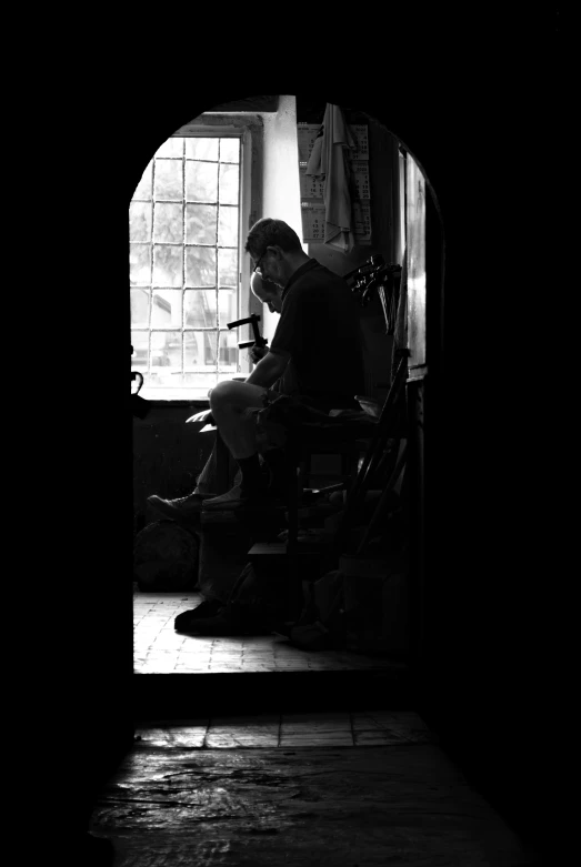 a black and white po of a person sitting in a chair