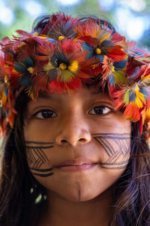  in native garb smiling at the camera