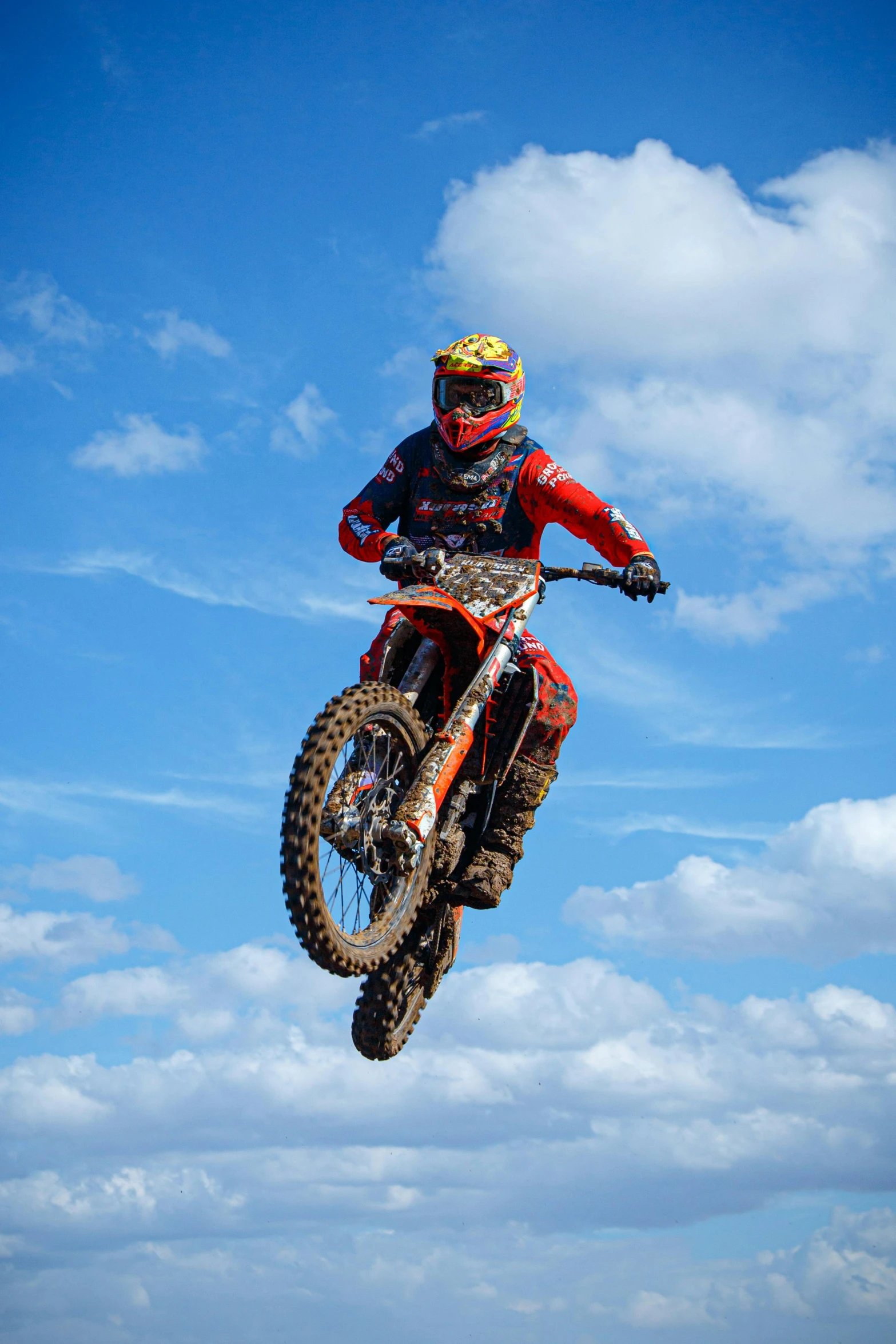 person jumping off his dirt bike on the beach