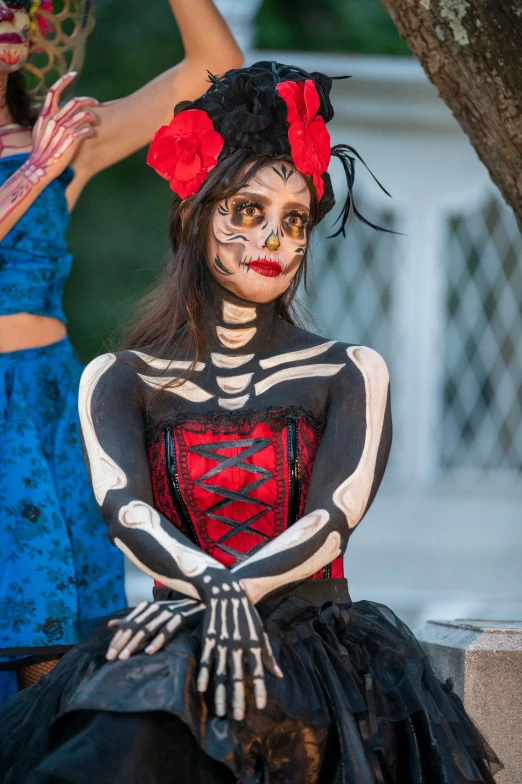 two women are in skeleton costumes on the street