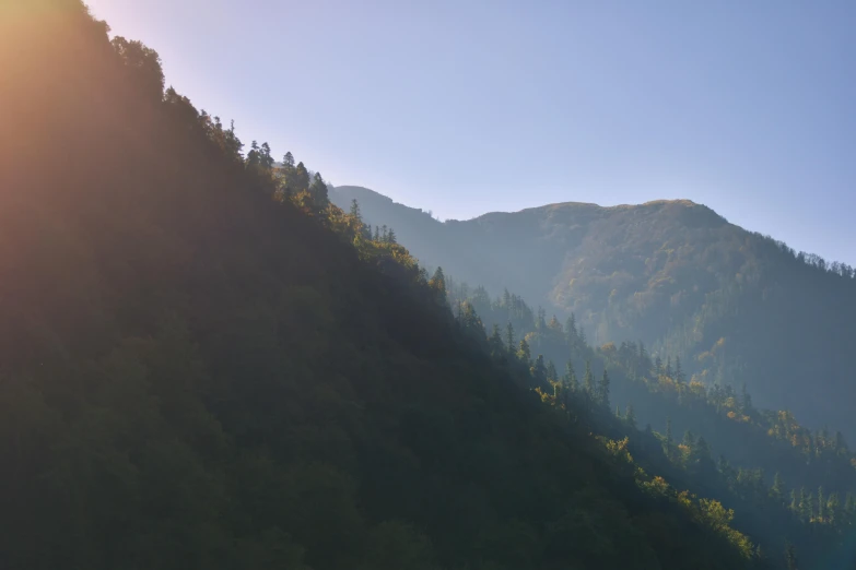 the top of the mountain with trees around it