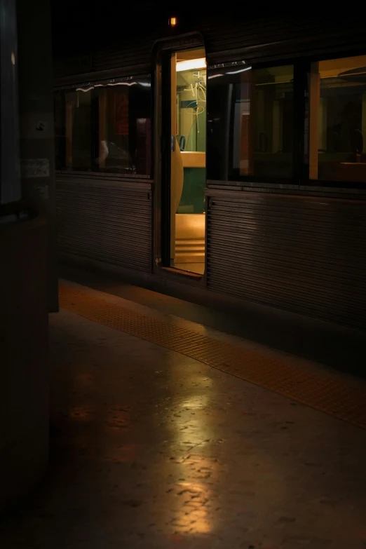 an empty train at night with the doors open