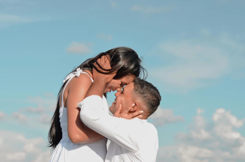 a young man hugging a pretty woman as she smiles