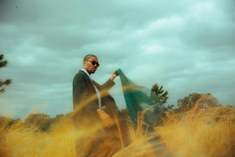 a person in a grassy field holding a green object