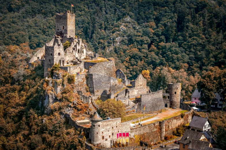 a tall castle surrounded by lush green hills