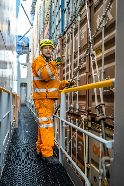 a worker is standing near the metal railing