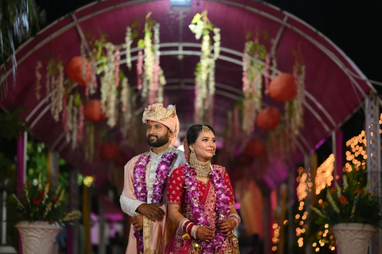 a man and woman are dressed up in traditional indian garb