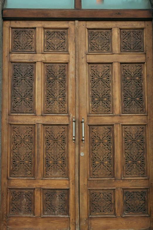 a very ornate wooden door with a cross on it