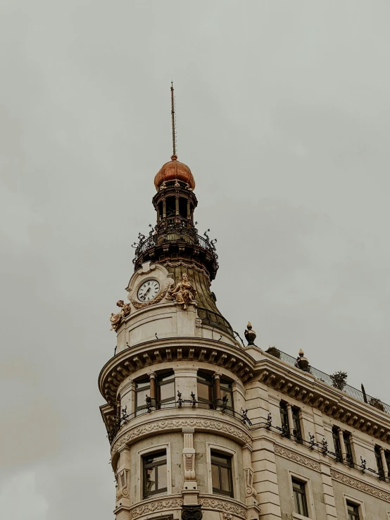 a clock mounted to the side of an ornate building