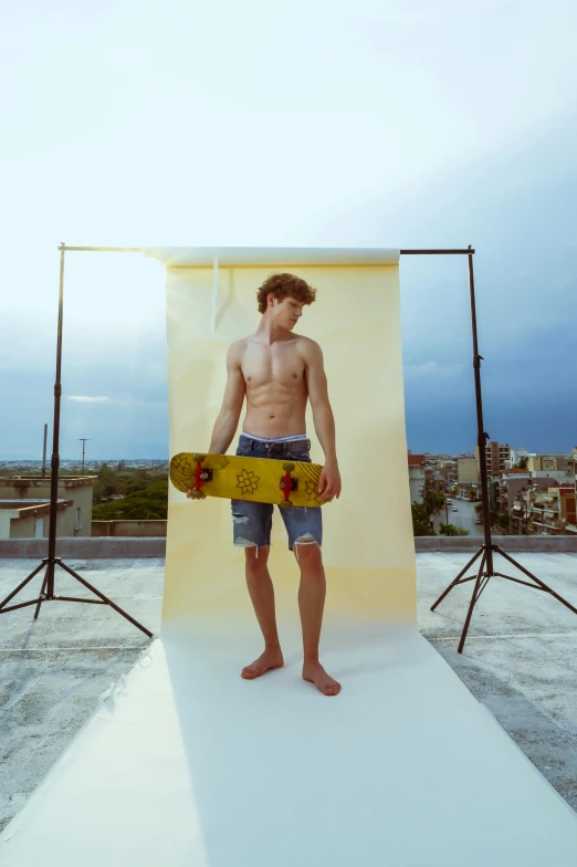 man with longboard on large white stage in open area