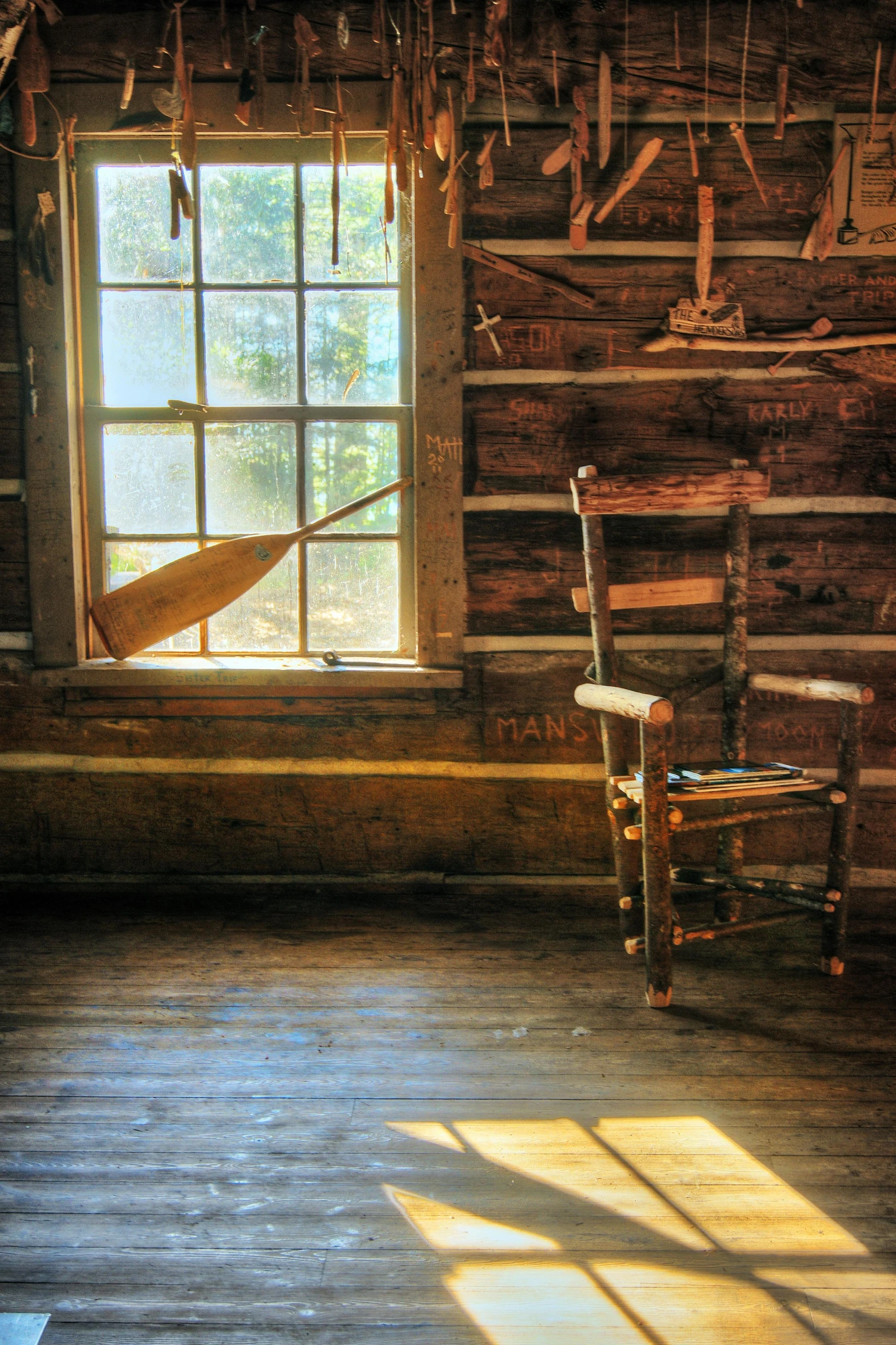 an old wooden cabin with sunbeams and windows