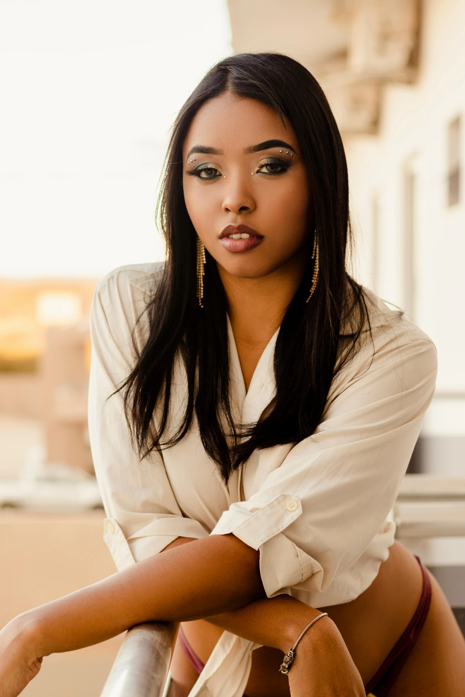 a woman with long brown hair posing