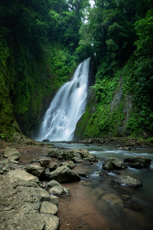 an outdoor waterfall with a lot of water in it