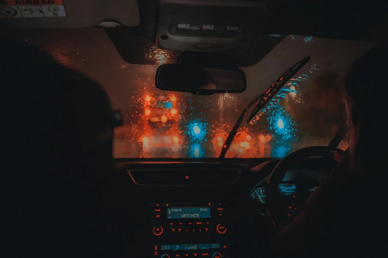 a view from inside the vehicle of people in cars