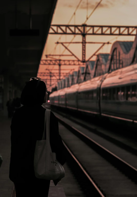 woman waiting for the train in the dark on a platform