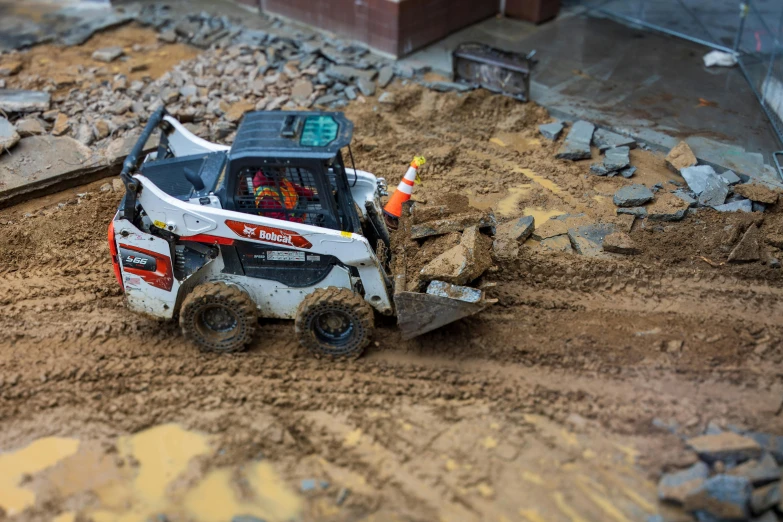 a ski - dool is going through some dirt on a road