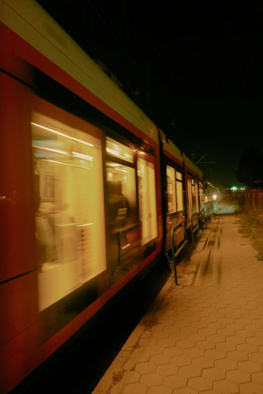 an image of a train moving down the track at night