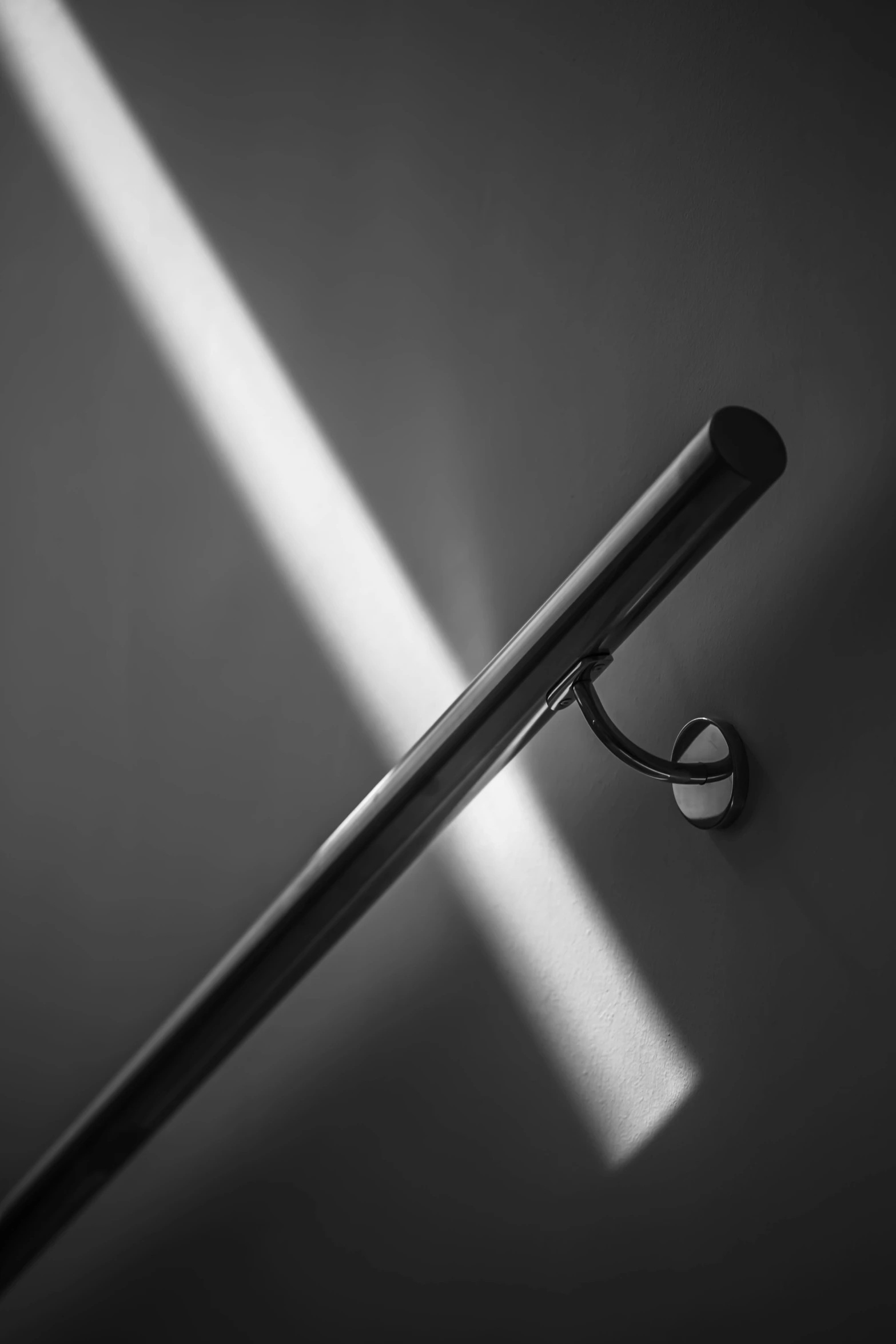 a black and white image of a umbrella hook