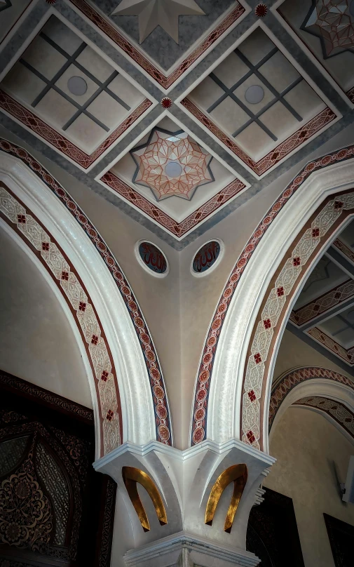 the ceiling is decorated with red and white designs