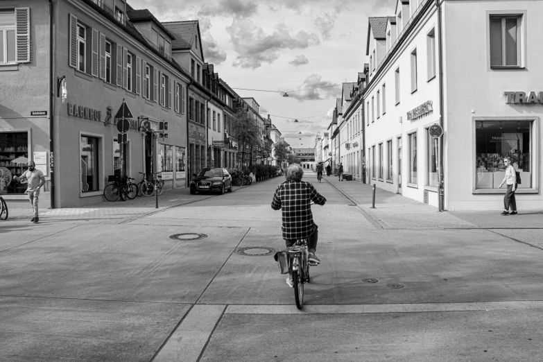 a black and white po of a person riding a bicycle