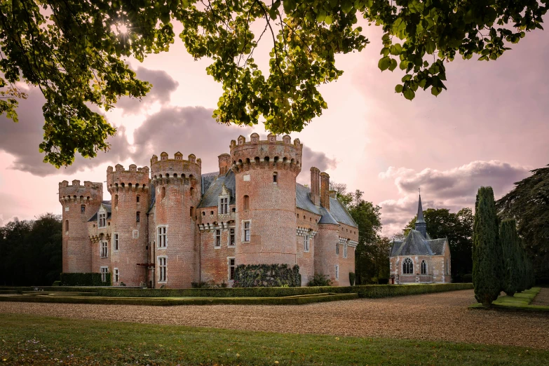 a large building with a tower near some trees