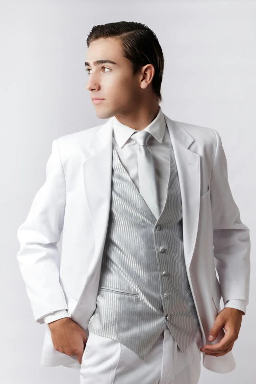 man in silver suit standing against a white background