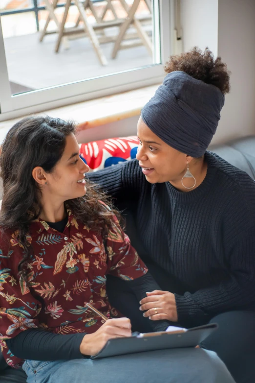 a woman is talking to another woman