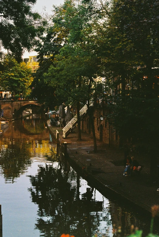 people sitting next to the water on boats in the city