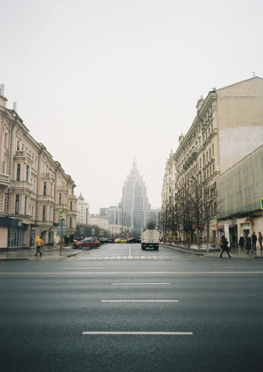 a city street with parked cars in front of buildings