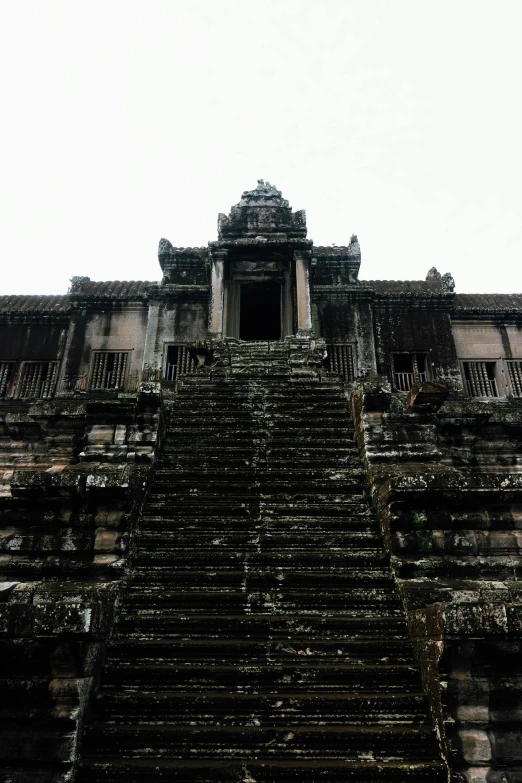 a large group of stairs leading up to a very old structure