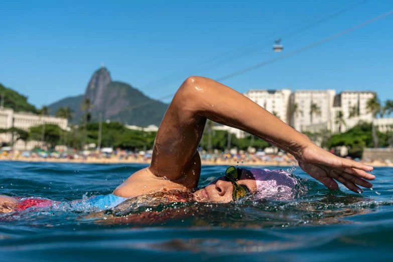 an adult lying on a board in the water