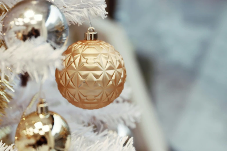 the ornament is hanging from a christmas tree