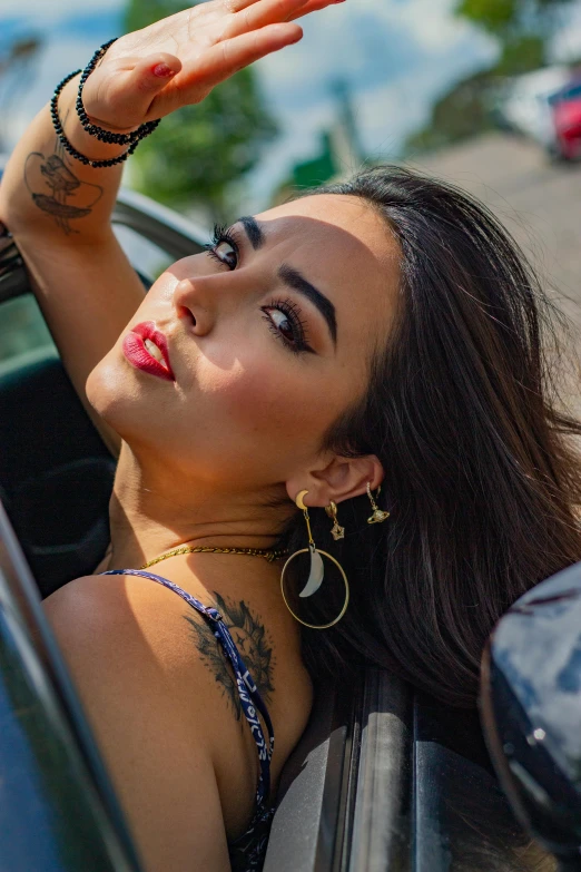 a woman leaning out the side of a car