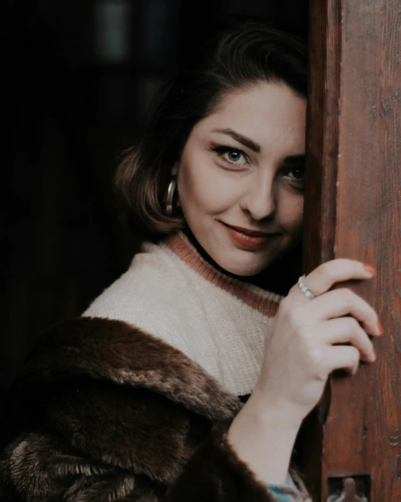 a woman smiles through the bars of an entrance